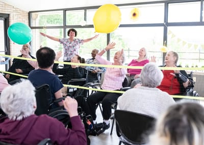Residents participating in a lively indoor activity session