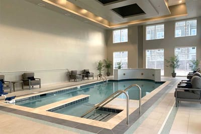 Indoor pool and lounging area in a modern setting