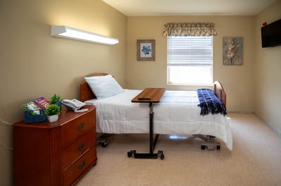 A well-furnished private resident room with a bed and window