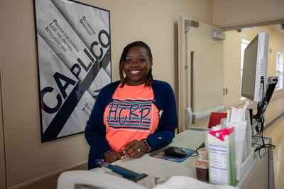 Staff member at reception smiling warmly