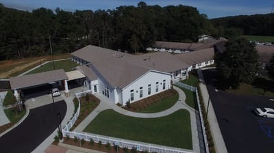 Aerial view of the TLC Nursing Center with landscaping