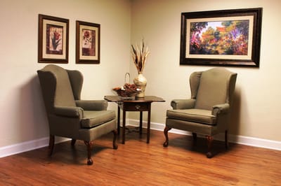 Cozy interior seating area with armchairs and artwork