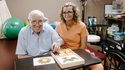 Resident and staff member playing a game