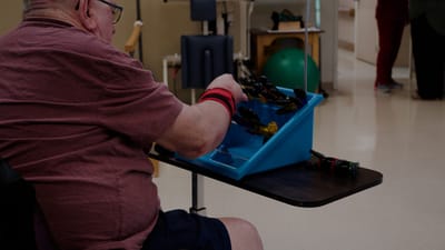 Resident engaging in an activity with colored tools