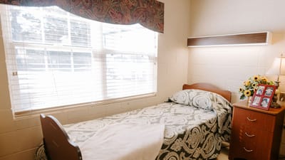 Cozy resident bedroom with a floral bedspread