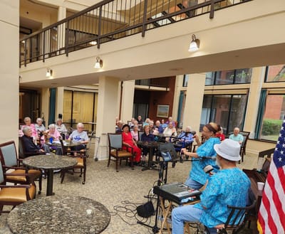 Woodland Heights, assisted living in Little Rock, AR — Seniors enjoying a live music performance in a common area