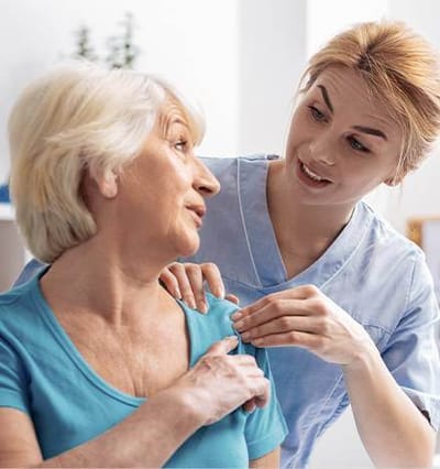 Staff assisting a resident in a bright room