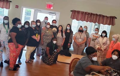 Staff and residents gathered in an activity room