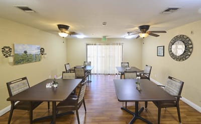 Bright common area with dining tables and chairs