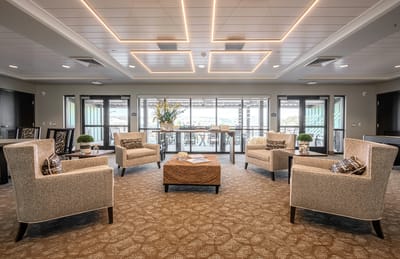 Bright common area with chairs and large windows