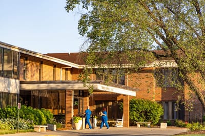 Exterior view of Trinity Center with staff walking outside