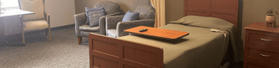 Comfortable resident room with bed and seating area