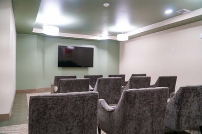 Common area with chairs and a television