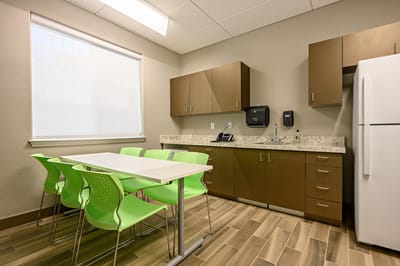 Modern dining area with green chairs and a table