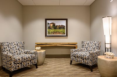 Interior seating area with decorative chairs and artwork