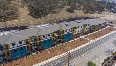 Aerial view of the facility building exterior with landscaping