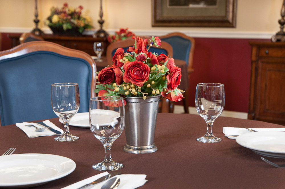 Table setting with floral centerpiece in dining room