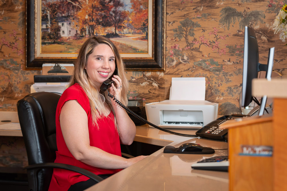 Staff member assisting at the reception desk