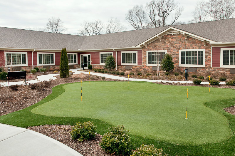 Beautifully landscaped outdoor space with a putting green