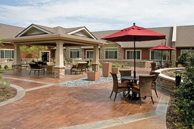 Outdoor seating area with umbrellas and landscaping