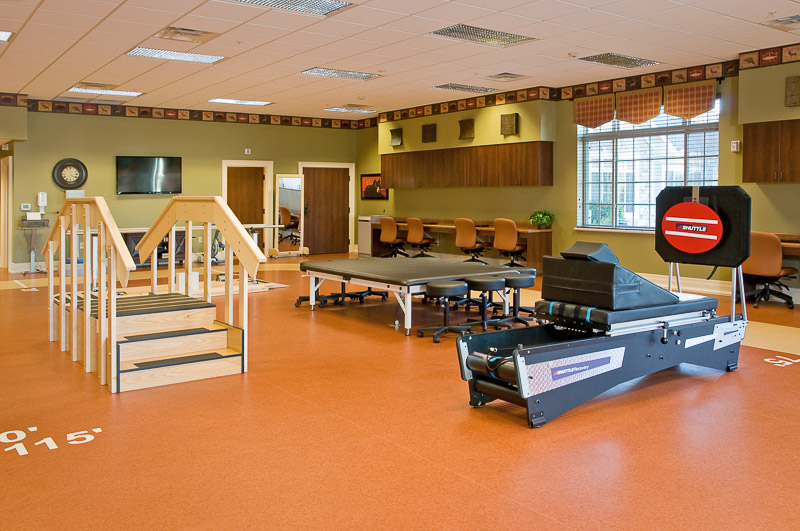 Therapy room with equipment and treatment areas.