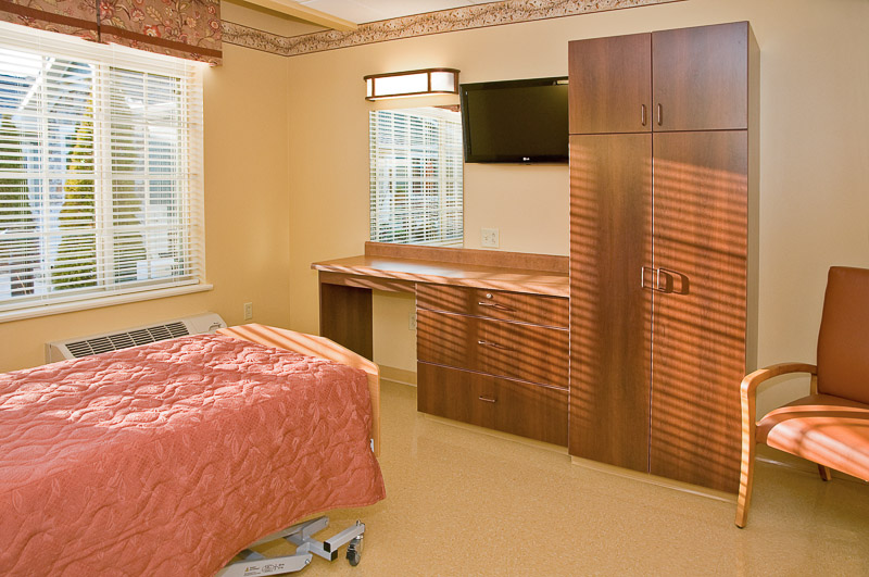 Bright private resident room with a bed and furnishings