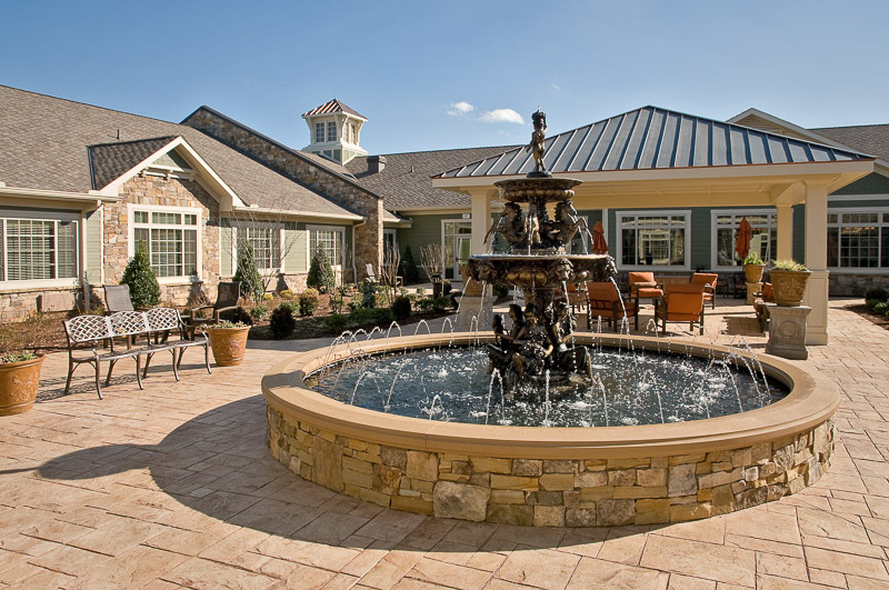 Outdoor courtyard with a fountain and seating area