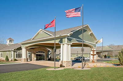 Entrance of the Life Care Center of Ooltewah with flags