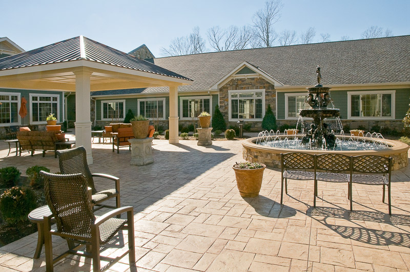 Outdoor patio area with fountain and seating