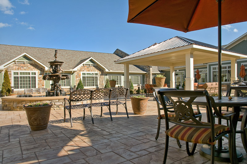 Outdoor patio area with seating and fountain