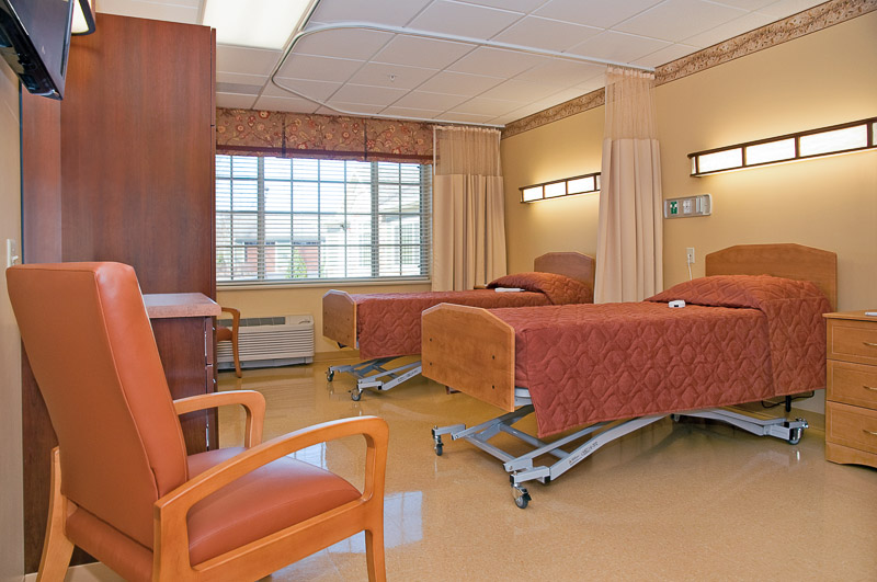 A cozy interior room with two hospital beds