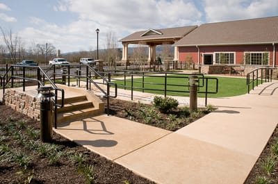 Exterior view of the assisted living facility with landscaped pathways