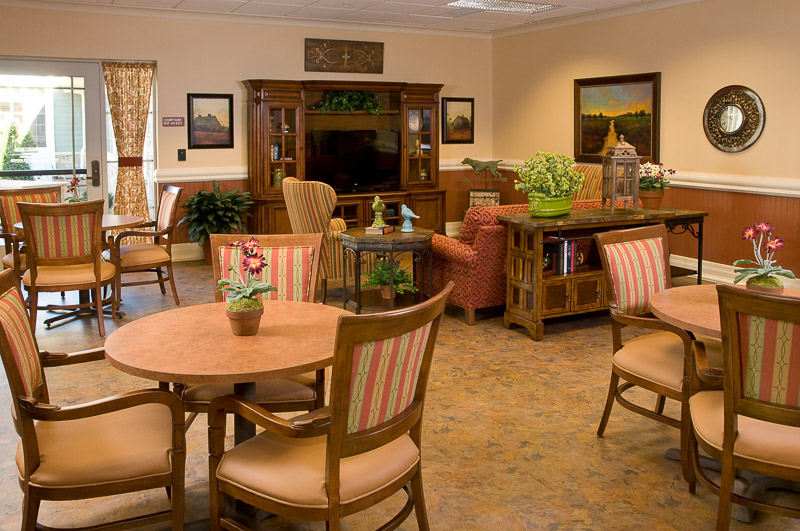 Bright common area with tables and chairs in a cozy setting