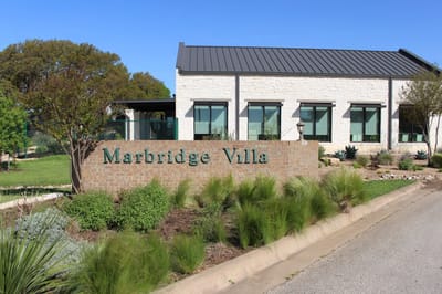 Exterior view of Marbridge Villa building with entrance sign