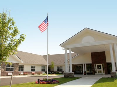 Exterior view of The Willows at Howell with flag