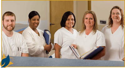 Staff members standing together in a clean, bright facility corridor