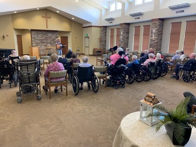 Residents enjoying a musical performance in a common area