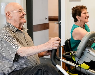 Residents engaging in physical exercise on recumbent bikes