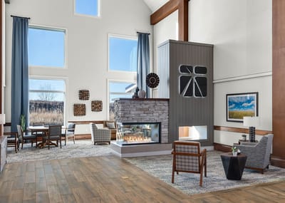 Bright interior common area with seating and fireplace