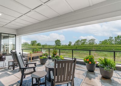 Outdoor patio area with seating and flowers