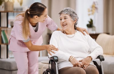 Staff member engaging with a resident in a cozy interior