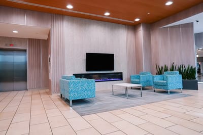 Bright common area with seating and fireplace