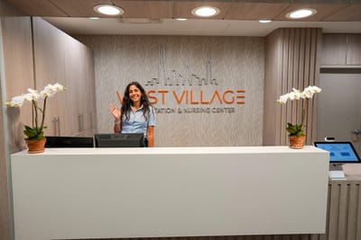Staff member at the reception desk in a bright lobby