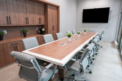 Modern conference room with a long table and chairs