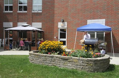 Outdoor BBQ area with residents enjoying the day