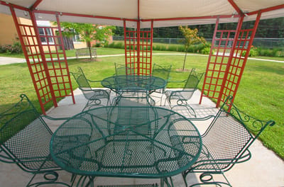 Shaded outdoor seating area with tables and chairs