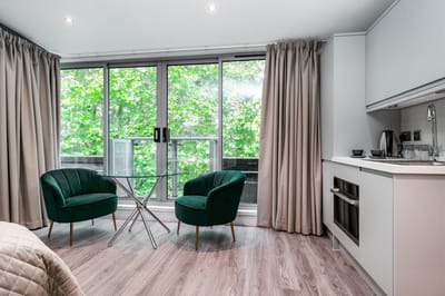 Interior view of a cozy living space with greenery outside