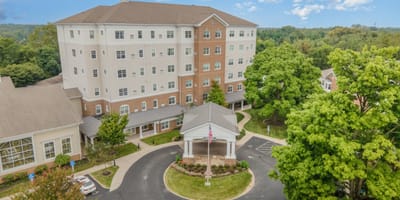 Aerial view of a senior living facility surrounded by greenery