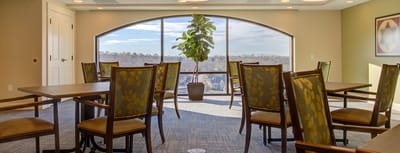 Bright common area with large windows and plants