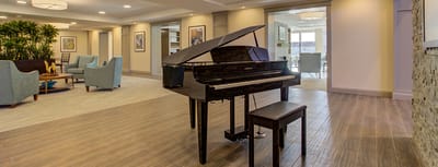 A piano in a cozy common area of the facility